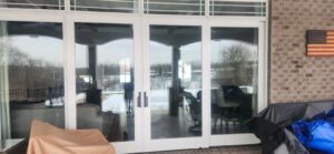 Before and after comparison showing a corroded, bent sliding door track repaired with a stainless steel track cap in West Chester, Ohio.