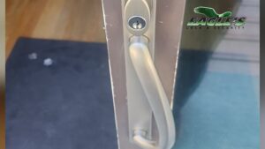 Eagle's Locksmith technician performing residential sliding door repair in Fairfield Ohio 45014 by replacing worn rollers and the door lock handle.