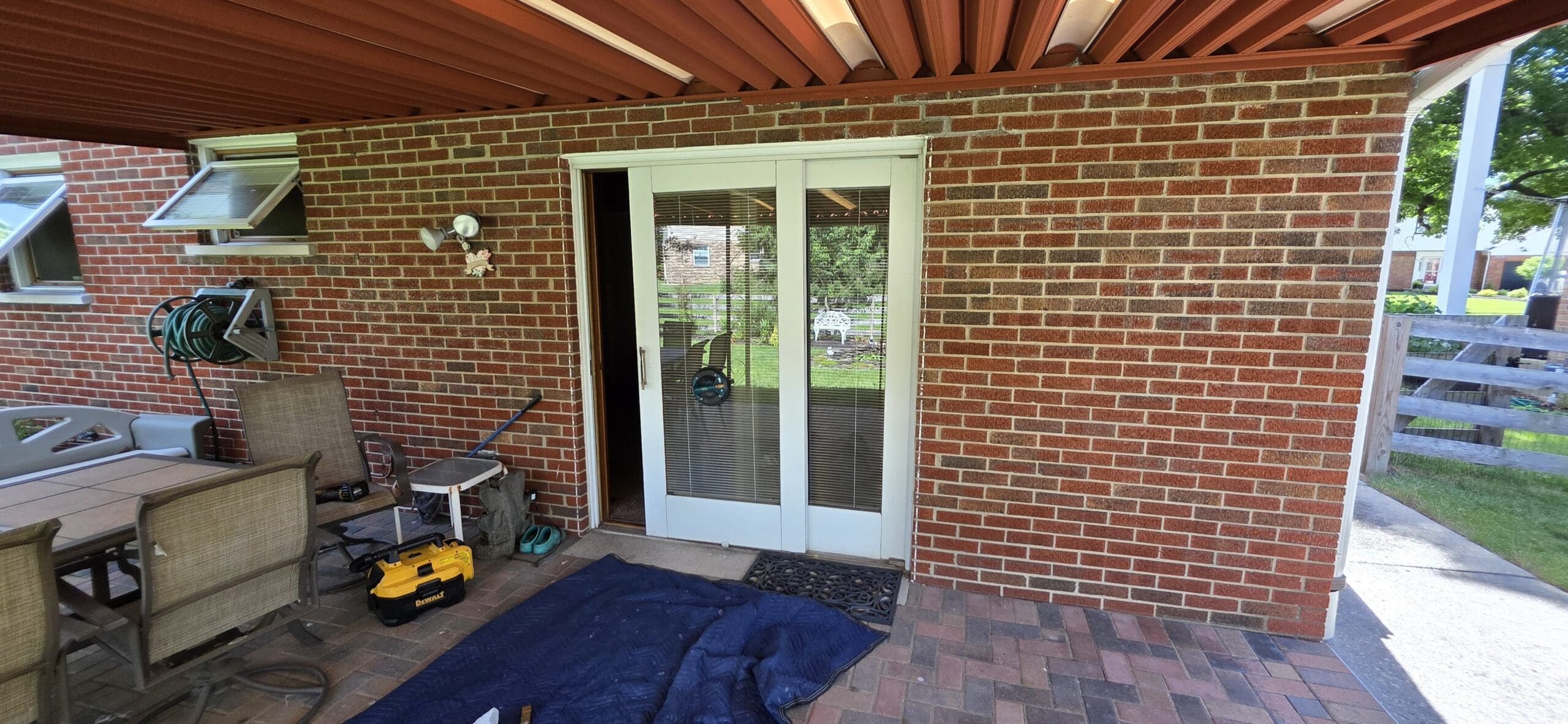 Eagle's Locksmith technician repairing a sliding glass patio door in Florence, KY